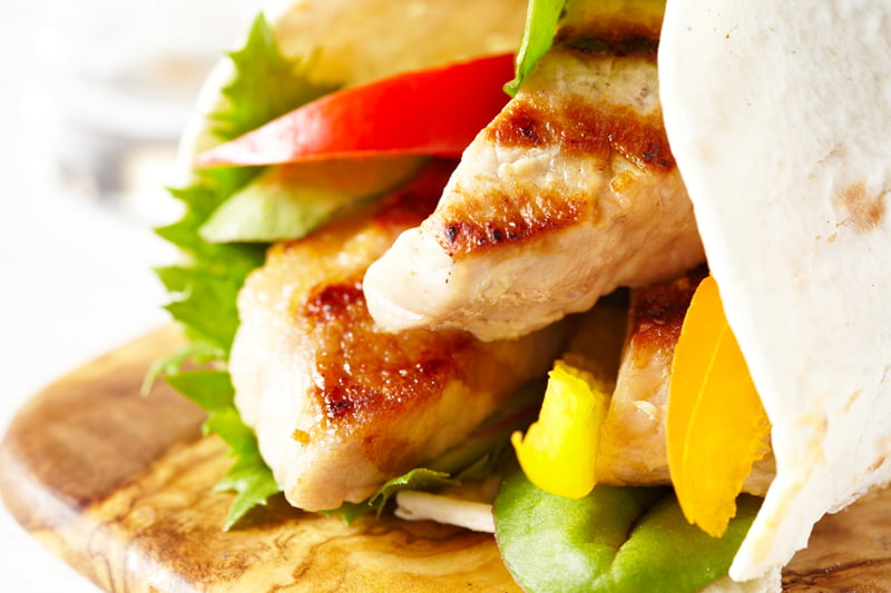Fresh tortilla wrap with grilled pork and vegetables