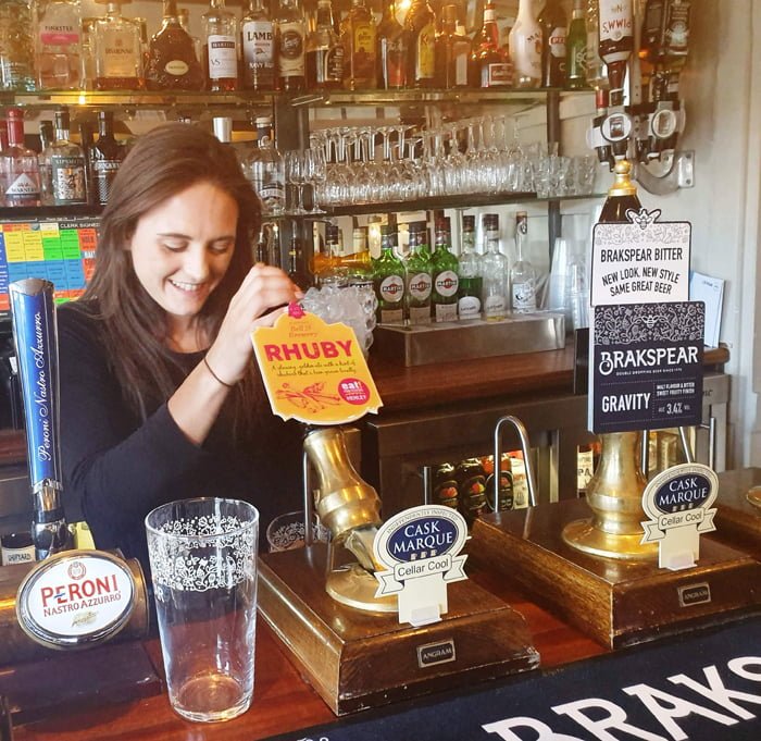 Bella Redrup, team member at the Angel on the Bridge, pours a pint of Rhuby